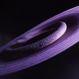 a purple object with water droplets on top