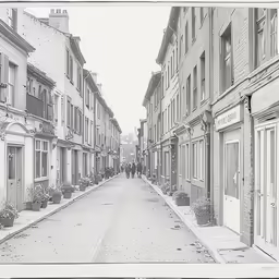 an old black and white photo of a street in a town