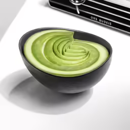 a black bowl with cut up avocado in it