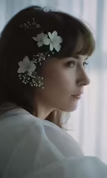 a woman with her hair in a flowery head piece