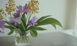 flowers in a glass vase sitting on a table