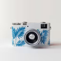 a blue and white camera with leaves on it