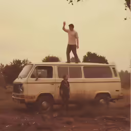 an old van with two children sitting on top