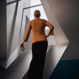 a woman standing in an abstract space wearing a suit