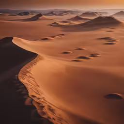 a sand dune covered in small dunes and mountains