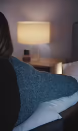 a woman laying on the bed with her stomach exposed