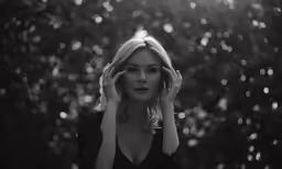 the woman is posing for a picture in black and white