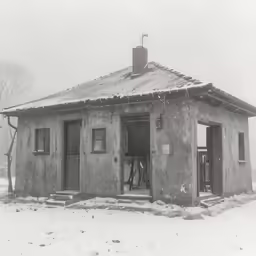 there is a small building that has snow falling on it