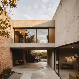 a cement walkway leading into an outdoor living room
