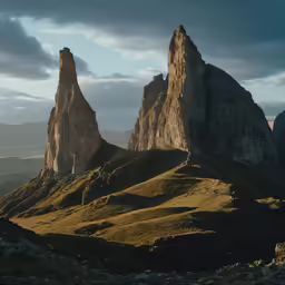 some mountains and trees with a cloudy sky