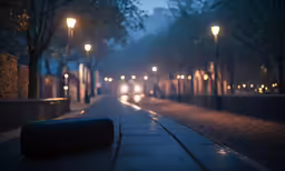 long road with street lights at night and cars driving on the street