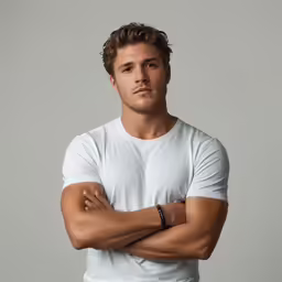 a man in white t - shirt with his arms crossed