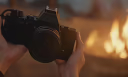 a woman holding a camera up to the camera