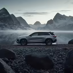 the suv is parked on rocks near the water