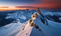 the tower is built into the snow covered mountains