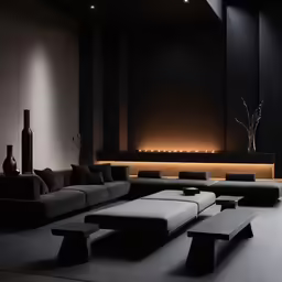 a living room with black furniture and a large light