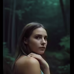 a woman in a blue dress with her hair swept back