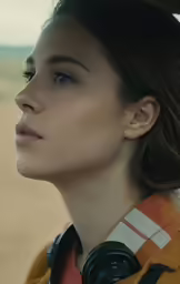 the woman with large earring is looking ahead