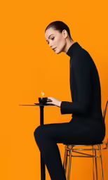 a woman is sitting at a table with a candle