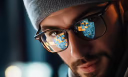 a man wearing glasses that have mosaic art on them