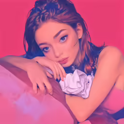 a person sitting in a bed with pink sheets