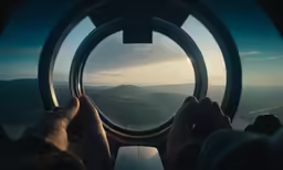 two people are looking out an airplane window