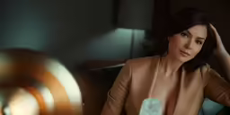 the lady is in a brown dress at a table