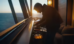 a man in glasses looking at something inside of an oven