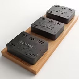 a pair of black soaps on a wooden display