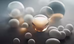 group of different sized and colored spheres and eggs