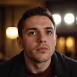 the young man is looking straight ahead at the camera