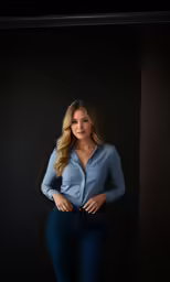 a woman posing for a picture in a blue shirt