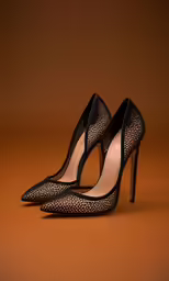 a black pair of shoes with a heel and a high - heeled shoe in the shape of a bow