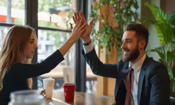 a man in a business suit giving a woman high five