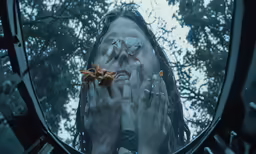 a person with their hand over their face with both hands