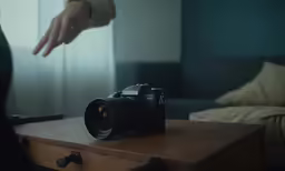 man getting a camera with his hand from another person