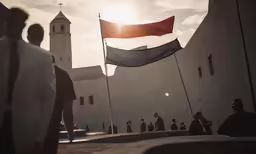 a man is walking outside by a red flag