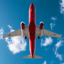 there is a large red airplane that is flying in the sky
