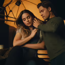 a man adjusting a ladys collar with her hands