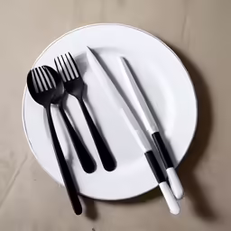 black and white fork, spoon and knife set