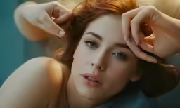 a woman looking at the camera while wearing an ad