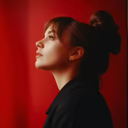 a close up of a person with hair in a bun