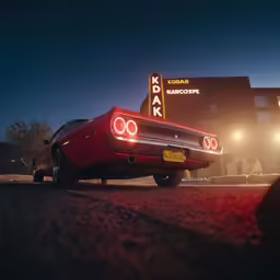 a red car parked in front of a business building at night