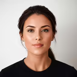 a beautiful woman posing with brown eyes wearing black shirt