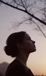 a woman is standing in the sky by some trees