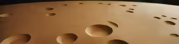 a wall sculpture made with different sized holes