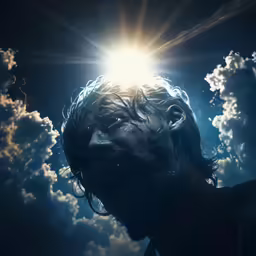 a man standing in the middle of clouds with the sun shining through his hair
