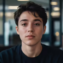 a close up view of an asian male in a t - shirt