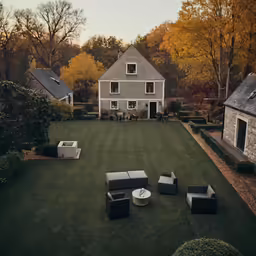 a lawn filled with lots of furniture sitting in front of a house