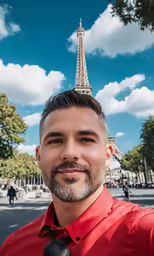 a man poses for a photo in front of the eiffel tower